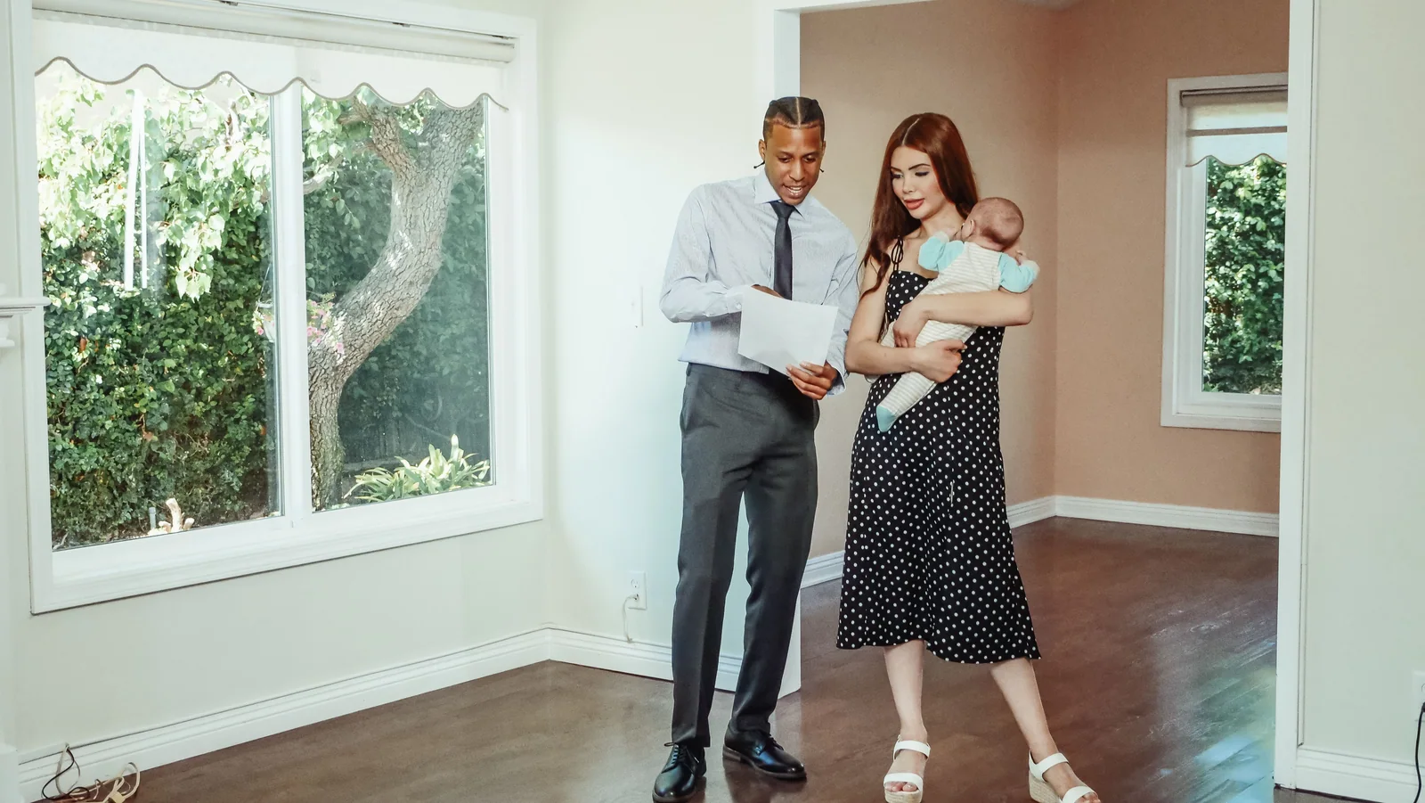 Família visitando um imóvel vazio com um profissional